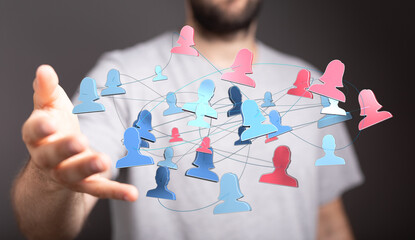 Close up shot of a network concept with people icons connected to each other, held in the open palm of a person