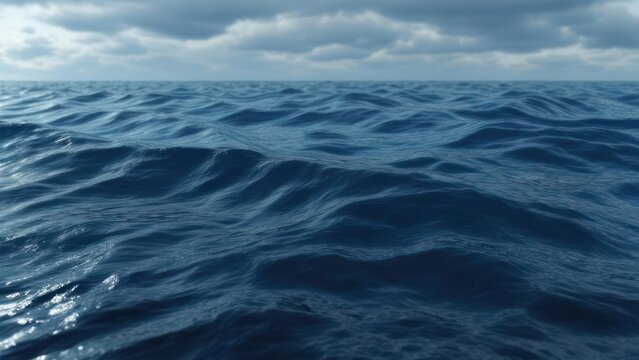 Dark blue ocean waves under a cloudy sky