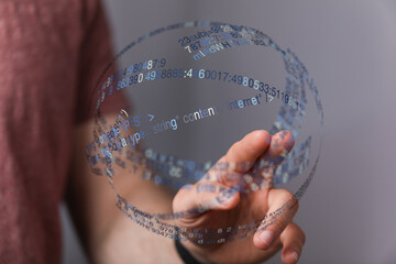 Hand reaching towards a digital sphere with data code floating. Concept of data, internet, network, future, technology, and connectio