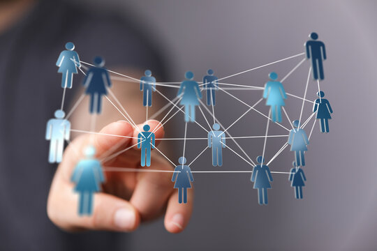 Hand touching a network of connected human figures, representing global business, communication, and social connections.