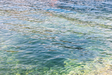 Vibrant sea  water surface with colorful reflections on soft waves