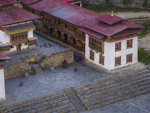 Aerial view of Haa Dzong's traditional architecture, where red roofs contrast with white walls and stone courtyards, Haa, Bhutan.