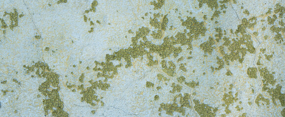 Peeling painted concrete wall, cracks of green blue and beige, peeling paint of the old rough concrete wall, peeling paint texture