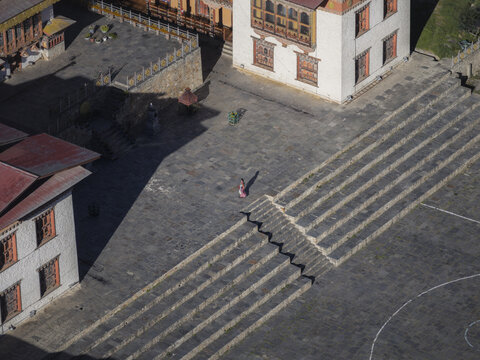 Aerial view of the patterned stone courtyard of Haa Dzong, exhibiting a dance of shadows and light, Haa, Bhutan.