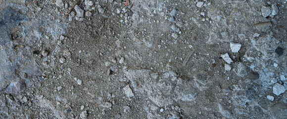Close-up of a gray-black lava texture on the ground. Porous, cracked, and stony, perfect as a stock texture or photo background. Impression of molten rock.