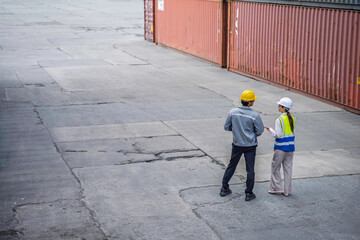 High angle view of professional logistics team discussing operations at cargo container terminal....