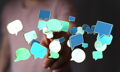 Hand holding interconnected speech bubbles representing online messaging, social networking, and...