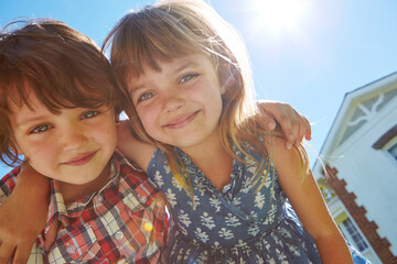 Happy, smile and portrait of children outdoor for bonding in backyard together with sunshine. Low...