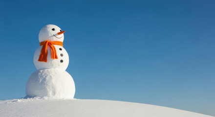 Snowman Isolated Against Blue Sky With Orange Scarf. Festive winter holiday scene with space copy joyful outdoor