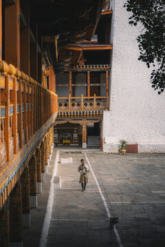Punakha, Bhutan - 19 September 2025: View of the architectural details of Punakha Dzong, with its vibrant orange wood contrasting against the white walls, creating a mesmerizing visual harmony.