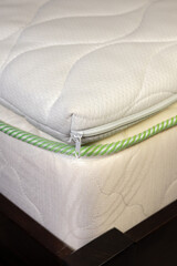 Mattress filled with coconut chips. Firm orthopedic mattress topper. Vertical photo.