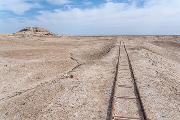 Train tracks which were used for excavations, railway tracks stretch into a barren landscape in Uruk, Iraq