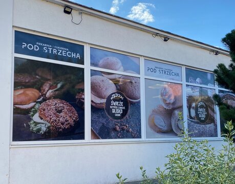 Poznan, Poland - August 26, 2025: Bakery named Pod strzecha storefront with enticing pastry displays in large windows, showcasing fresh baked goods and inviting atmosphere for customers to enjoy
