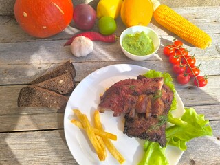 fried ribs on a white plate with French fries. High-quality photos