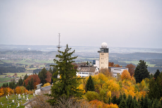 Historic weather station tower atop Hohenpei&szlig;enberg, radar dome and labs amid autumn forest, symbolizing climate research, ideal for science and environmental topics.