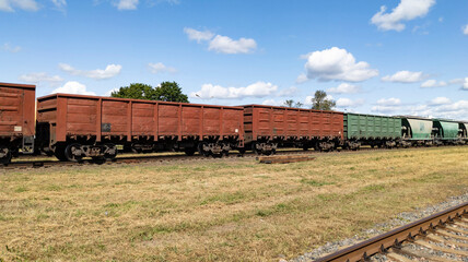 Railroad cars for transporting freight and oversized goods. Freight cars. Freight transportation by rail. © yaviki