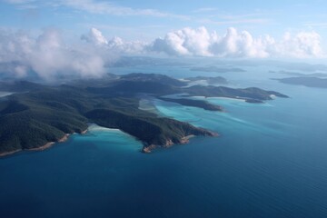 Aerial view of verdant islands and expansive ocean under cloudy sky