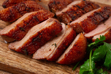 Roast duck breast, sliced, on a wooden chopping board,close-up, no people,