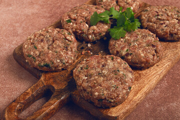 raw cutlets, minced meat, on a chopping board, homemade, top view, no people,