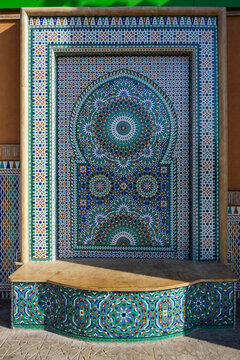 Ornate mosaic fountain with intricate geometric patterns and vibrant colors in a traditional style. Marrakesh, Morocco