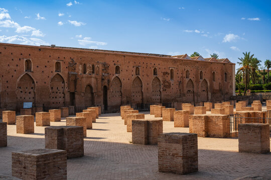Ancient brick ruins with rectangular pillars beneath a clear blue sky. Marrakesh, Morocco