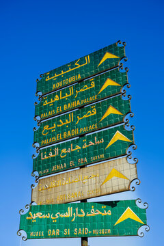 Multilingual signpost against a clear blue sky, directing to famous sites in Marrakesh. Agafay Desert, Marrakesh-Safi, Morocco