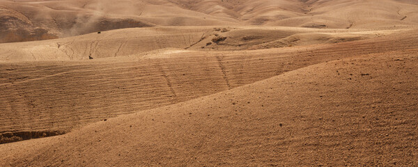 Rolling sandy hills under a clear sky in a desert landscape. Agafay Desert, Marrakesh-Safi, Morocco