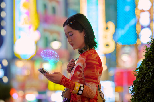 A young adult using a new AI smartphone with vibrant city lights in the background. Shanghai, China
