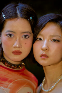 Two young women with bold makeup and hairstyles, close together, in a dramatic pose. Shanghai, China