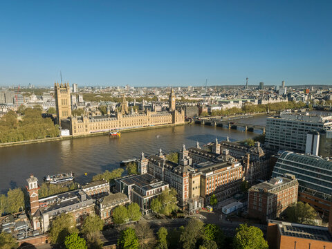 Aerial view of the Houses of Parliament and the River Thames on a clear, sunny day. London, UK
