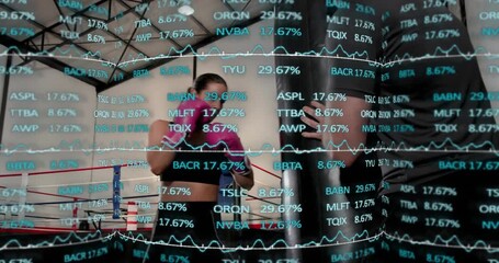 Coach calling pads, boxer jabbing mitts and bag, training, financial tickers over ring - Powered by Adobe