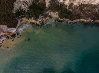 Aerial view of a rocky coastline with cliffs and clear blue-green water. Cartagena, Colombia
