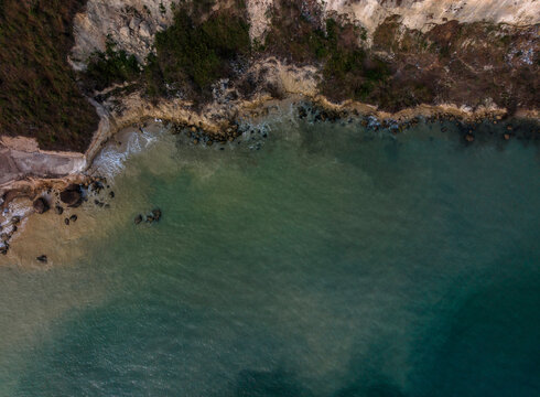 Aerial view of a rocky coastline with cliffs and clear blue-green water. Cartagena, Colombia