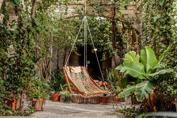 A cozy hammock surrounded by lush greenery in a serene garden courtyard. Sierra Alhamilla, Almeria, Spain