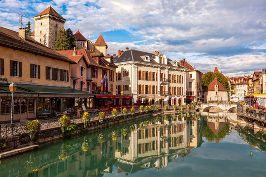 Picturesque view of colorful buildings and canal with reflections on a sunny day. Anncey, France