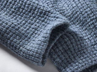 Close-up of soft blue textured fabric with a waffle pattern.