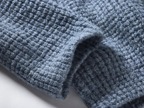 Close-up of soft blue textured fabric with a waffle pattern.
