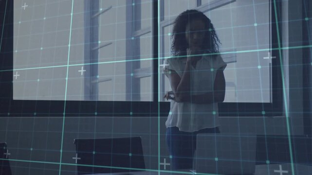 Woman leaning at table opening laptop in business meeting causing grid overlaying analyzing data