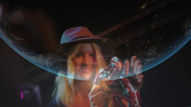 Female musician raising tambourine starting set tapping and singing into mic, globe overlaying face