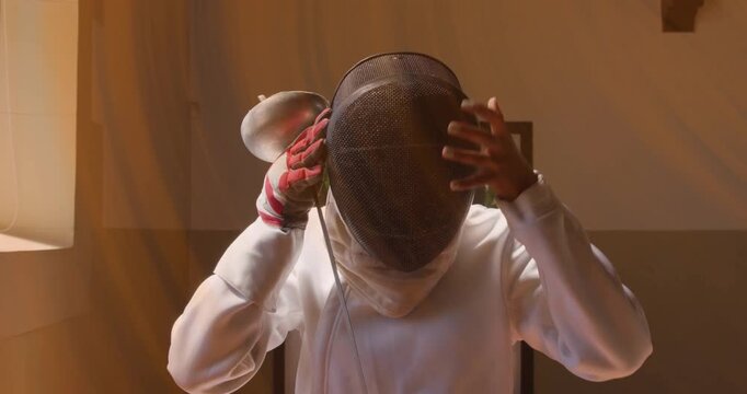 Woman lifting mask and holding sword, preparing for sports, animated light tracing mask fit