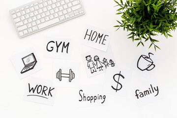 Many paper cards with hand drawing of different life activities with keyboard and green plant, top...