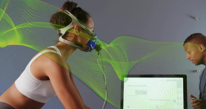 Woman cycling after tech pointing monitor, green flow overlay showing mask airflow for lab test