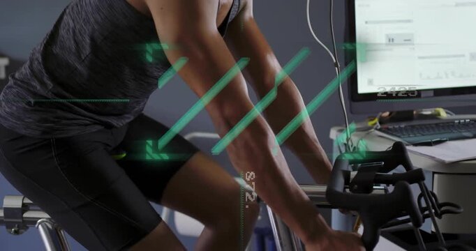 Male cyclist starting pedaling on stationary bike in VO2 lab, mask fitted, telemetry updating