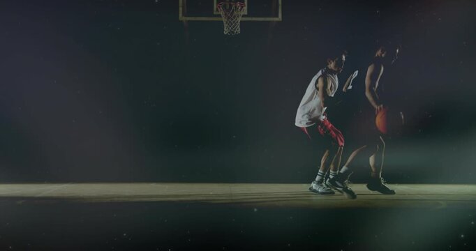 Player #12 dribbling and protecting ball from steal as defender approaching, shuffling under hoop