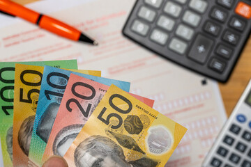 Taxes and financial settlements in Australia. Australian dollar, calculator, and tax form. Finance and business concept. Tax return. Flat lay. close up. Financial background
