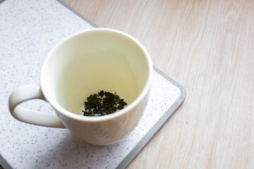 Loose green tea in a cup
