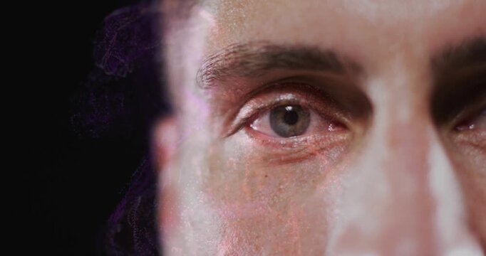 Mid-adult man holding gaze while nebula overlay drifts across cheek highlighting eye for design