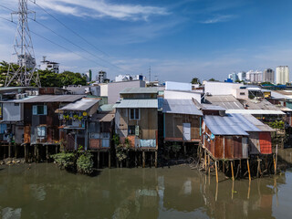 Waterfront slum houses along Kenh Te canal in Saigon or Ho Chi Minh City, Vietnam on a sunny day in district eight.