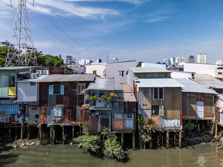 Waterfront slum houses close up along Kenh Te canal in Saigon or Ho Chi Minh City, Vietnam on a sunny day in district eight.