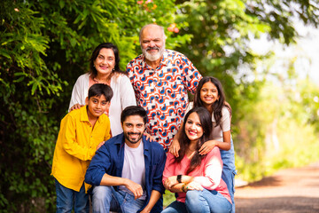 Fototapeta premium Indian family bonding happily while standing outdoors and smiling together